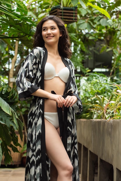 Beautiful young woman wearing summer clothes on tropical resort