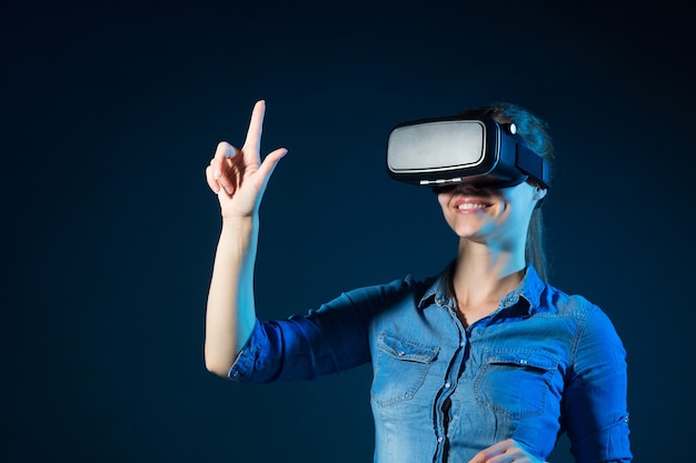 Beautiful young woman wearing virtual reality glasses