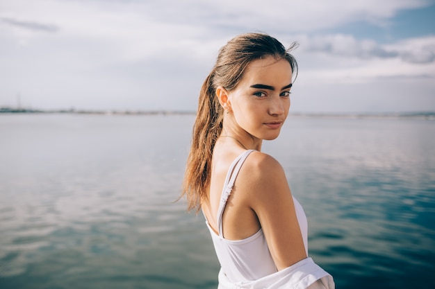 Beautiful young woman wearing a white top