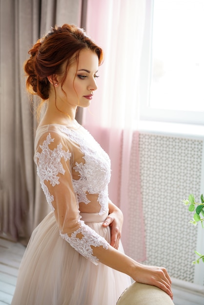 Beautiful young woman in wedding dress beautiful makeup and hairstyle happy bride.