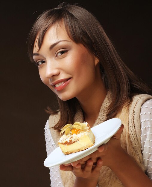 Beautiful young woman with a cake