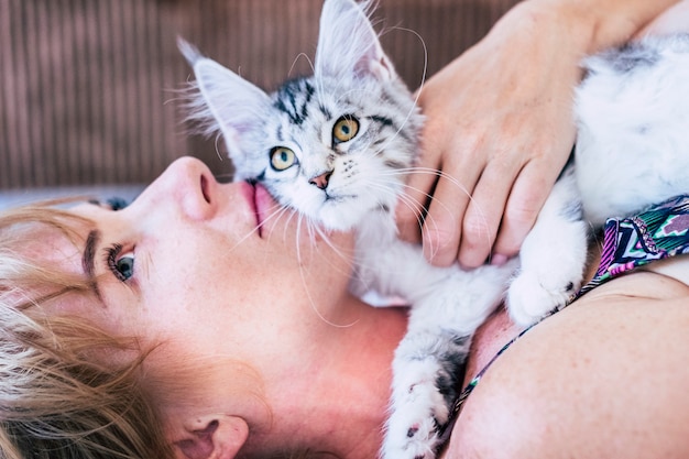 Beautiful young woman with cute cat resting at home