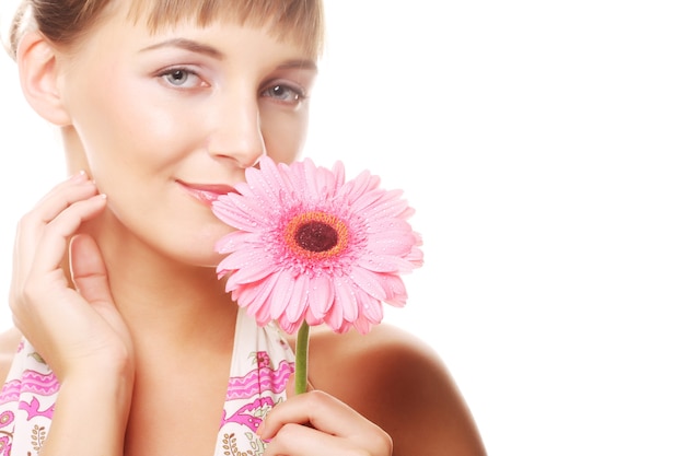 Beautiful young woman with gerber flower isolated on white 