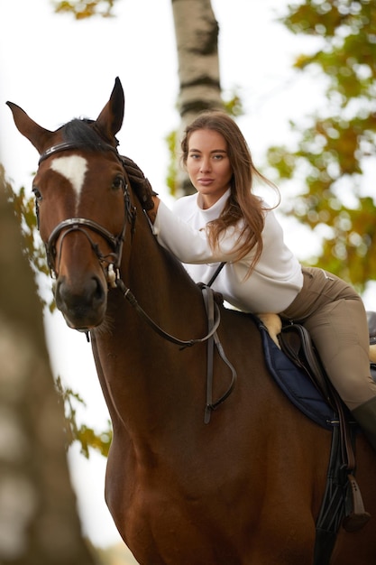 Beautiful young woman with horse outdoor Concept of animal care