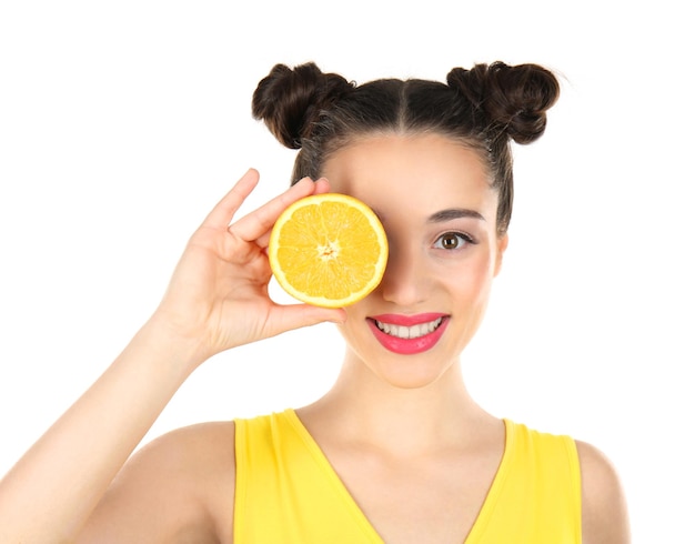 Beautiful young woman with orange on white background