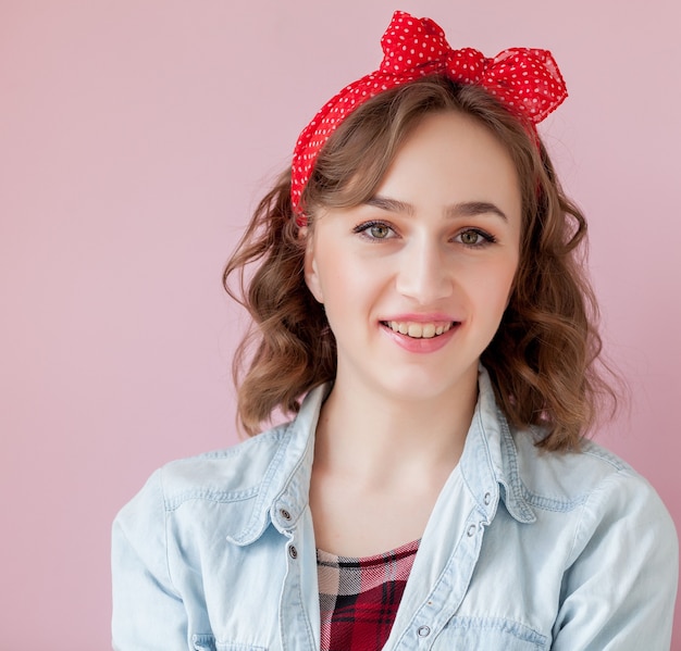 Beautiful young woman with pin-up make-up and hairstyle