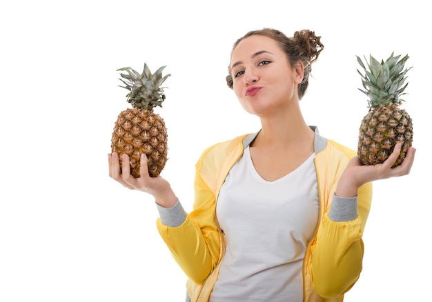 Beautiful young woman with pineapple isolated on white