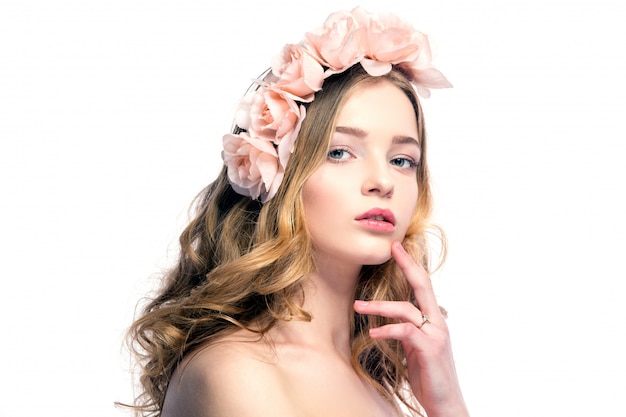 Beautiful young woman with pink flowers on head