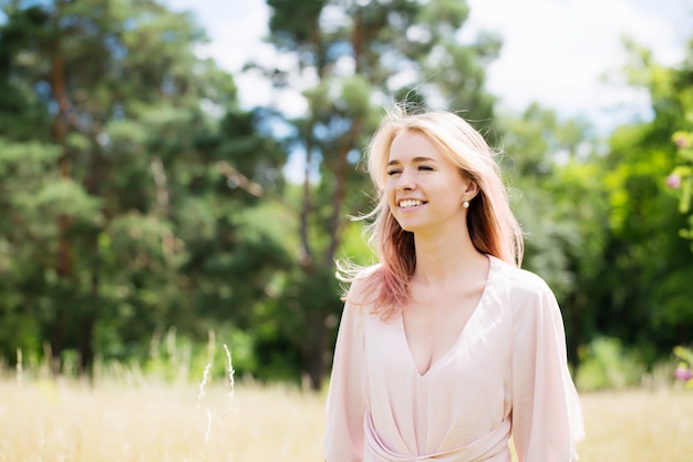 Beautiful young woman with pink hair in a pink costume