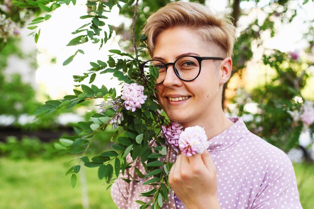 Beautiful young woman with short hair in the garden