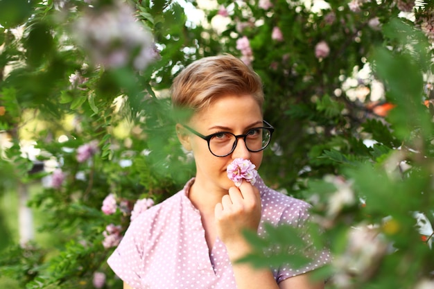 Beautiful young woman with short hair in the garden