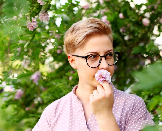 Beautiful young woman with short hair in the garden