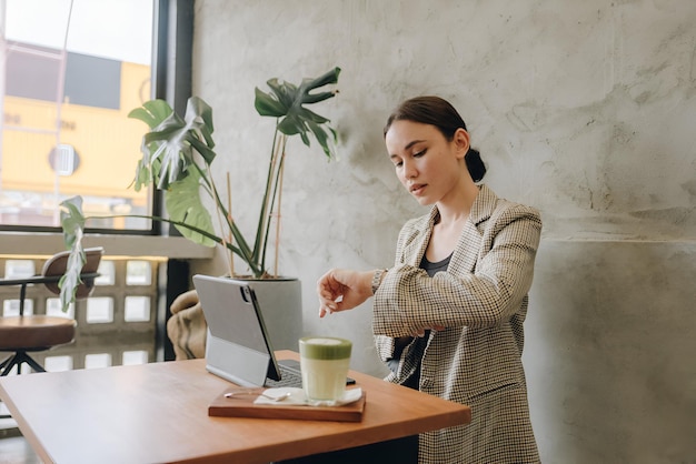 Beautiful young woman working on a laptop in cafe