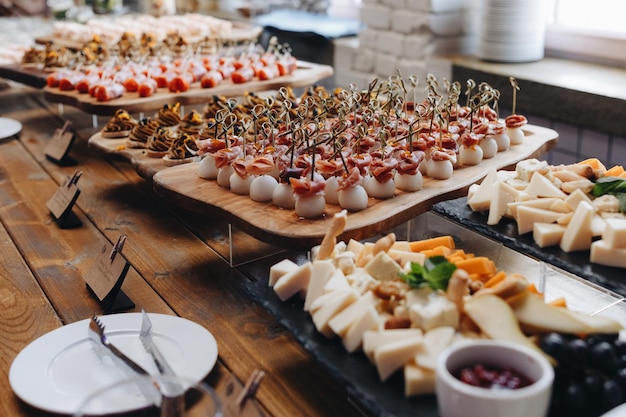 Beautifully decorated catering banquet table with different food snacks and appetizers with sandwich