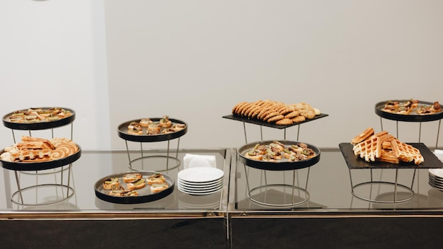 Beautifully decorated catering banquet table with different food snacks and appetizers with sandwich