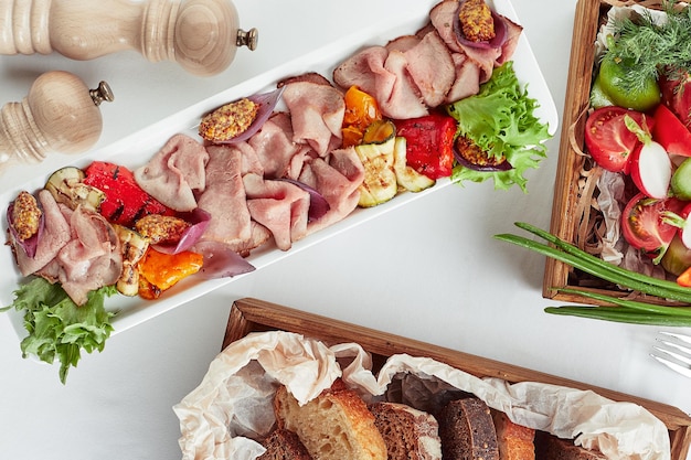 Beautifully decorated catering banquet table with different food snacks and appetizers.