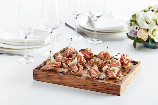 Beautifully decorated catering banquet table with different food snacks and appetizers