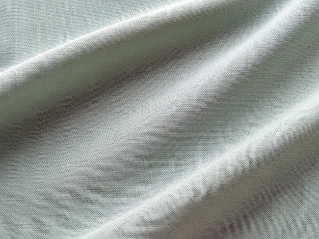 Beautifully folded light green fabric Soft pleasant waves and flounces on textiles upholstery