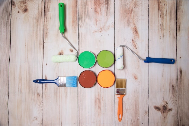 Beautifully laid out paints and brushes on a wooden surface