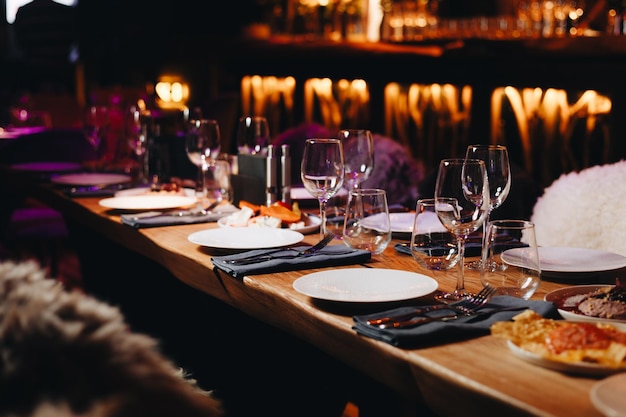 Beautifully organized event round served table banquet ready for guests round decorated table with empty plate glasses forks napkin Elegant dinner table