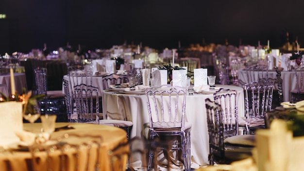 Beautifully organized event round served table banquet ready for guests round decorated table with empty plate glasses forks napkin Elegant dinner table