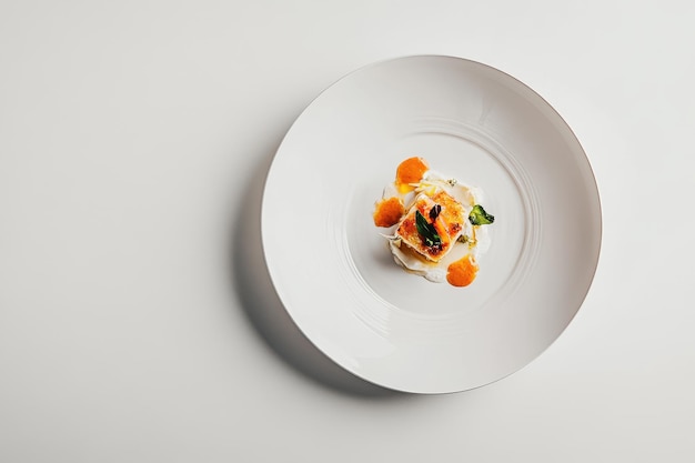 A beautifully plated gourmet dish on a minimalist white plate