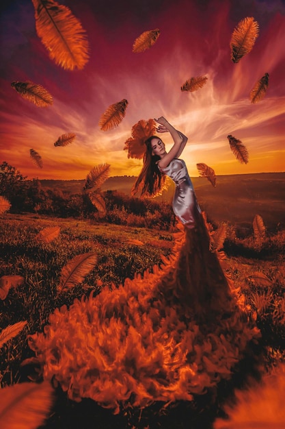 Beautiul woman in sunset with feathers