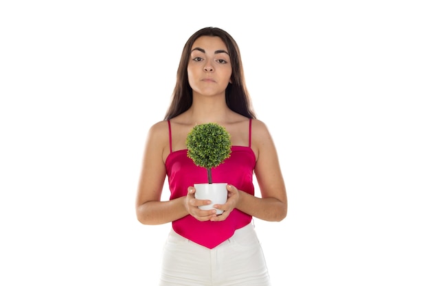 Beauty brunette woman with a green small tree