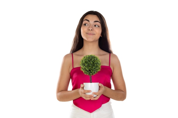 Beauty brunette woman with a green small tree