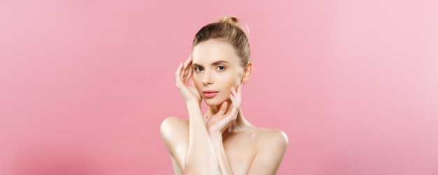 Beauty Concept Beautiful Caucasian woman with clean skin natural makeup isolated on bright pink background with copy space