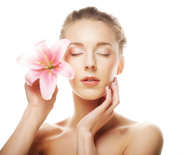 Beauty face of the young woman with pink lily