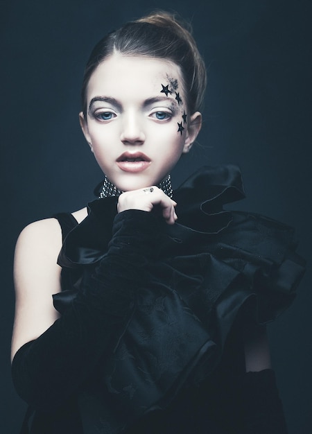 Beauty and fashion concept Little girl wearing black outfit Creative make up