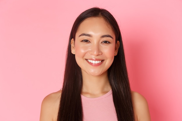 Beauty fashion and lifestyle concept closeup of beautiful happy asian girl with perfect white smile ...