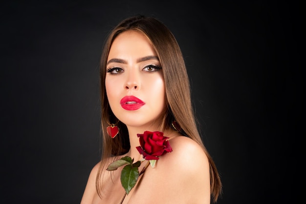 Beauty fashion portrait beautiful woman with makeup and rose flowers on black isolated background in