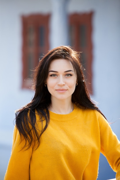 Beauty fashion portrait of young beautiful brunette woman with long black hair and green eyes