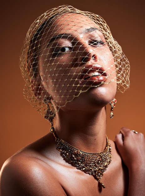 Beauty fashion and veil with portrait of woman for gold jewellery and vintage luxury Cosmetics retro and glamour with net on face of girl model for fancy graceful and accessory in studio