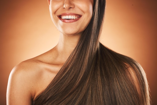 Beauty hair and keratin with a model woman in studio on a brown background for natural treatment Wellness luxury and salon with a female posing to promote a haircare product or shampoo