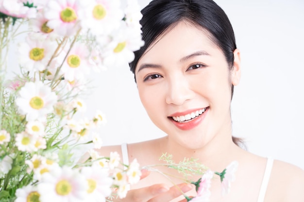 Beauty image of young Asian woman with flowers