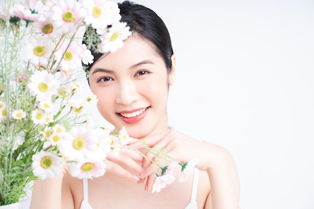 Beauty image of young Asian woman with flowers