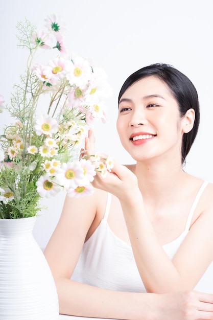 Beauty image of young Asian woman with flowers