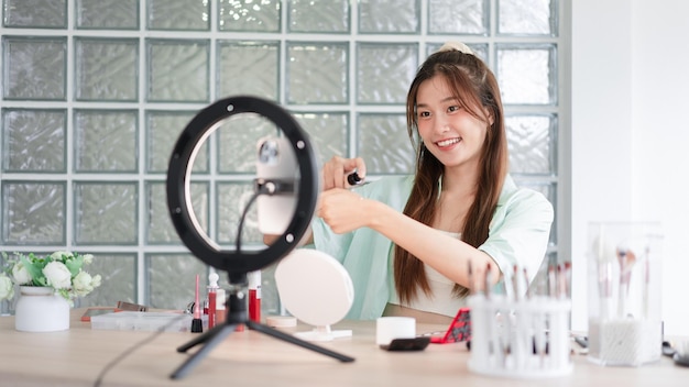 Beauty influencer concept Young woman dripping liquid foundation on hand to review product on Vlog