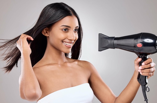 Beauty is an expression Shot of a beautiful young woman blowing her hair against a grey background