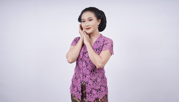 Beauty in kebaya showing spoiled sweet face isolated on white background