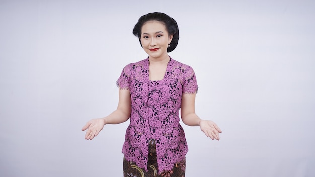 Beauty in kebaya smiling welcome gesture isolated on white background