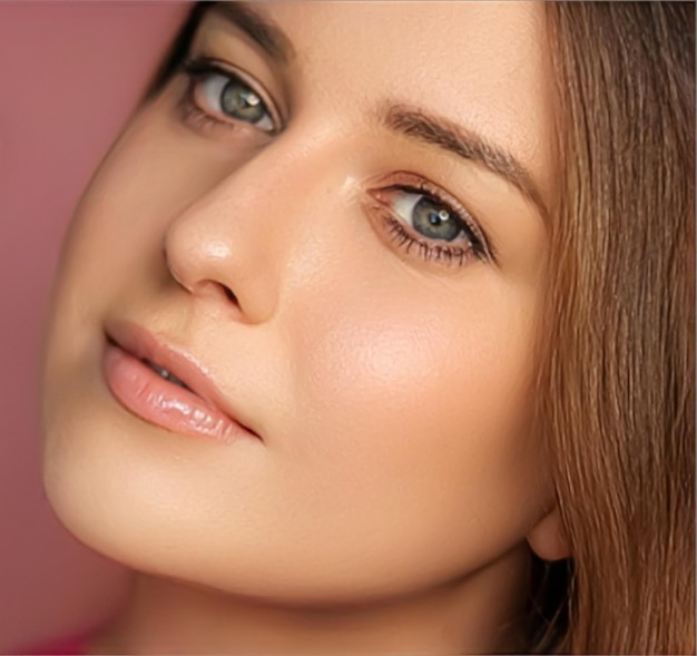 Beauty makeup and skincare cosmetics model face portrait on pink background beautiful woman with natural makeup perfect healthy skin glow facial care