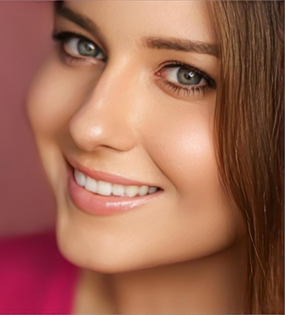 Beauty makeup and skincare cosmetics model face portrait on pink background smiling woman with natural makeup perfect healthy teeth dental care