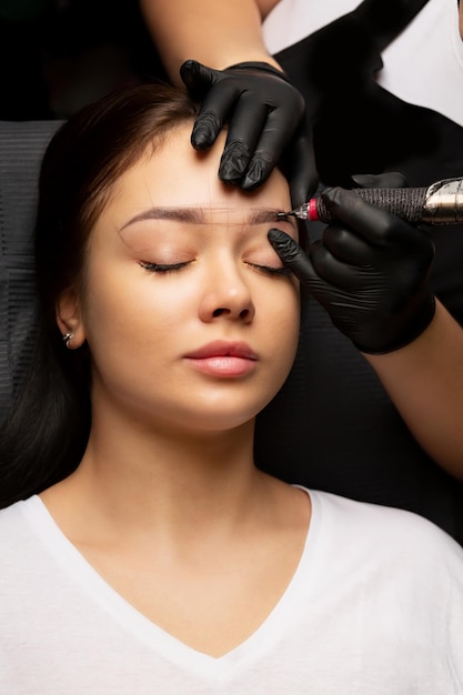 Beauty master applying permanent powder brow makeup