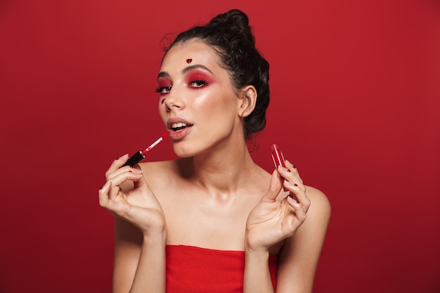 Beauty portrait of an attractive young topless woman wearing makeup standing isolated 