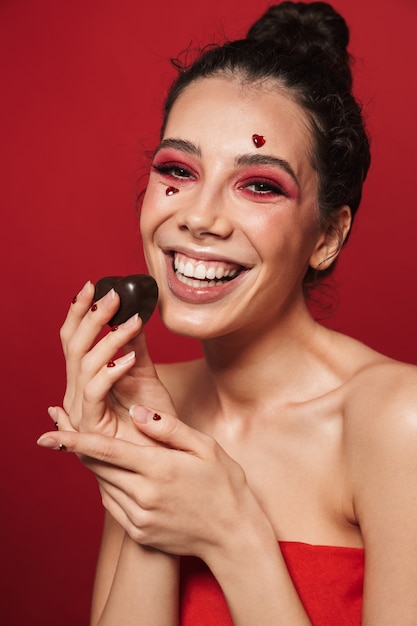 Beauty portrait of an attractive young topless woman wearing makeup standing isolated 