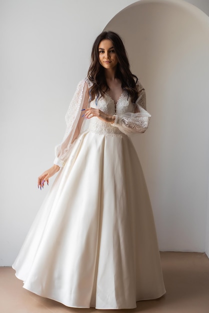 Beauty Portrait of bride wearing in wedding dress with voluminous skirt studio photo